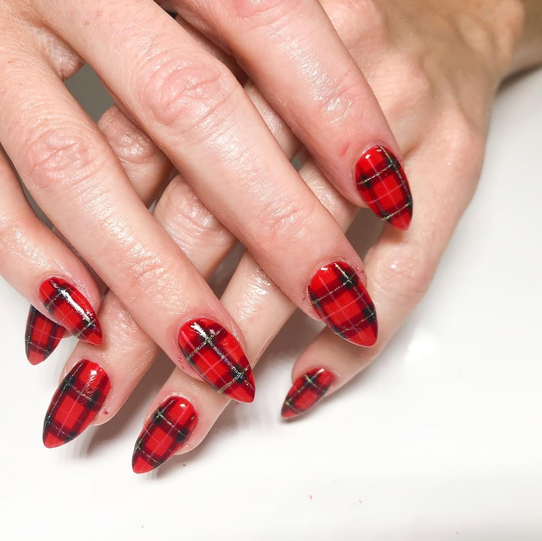Cherry-red almond nails with classic tartan plaid nail art