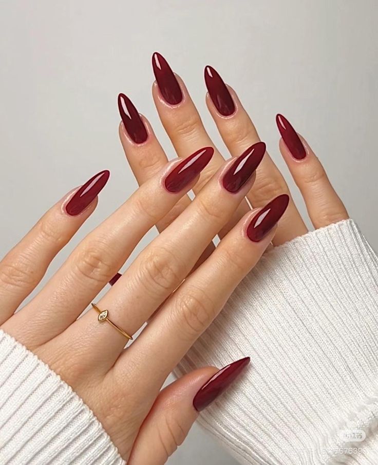 Glossy cherry-red almond nails in medium length