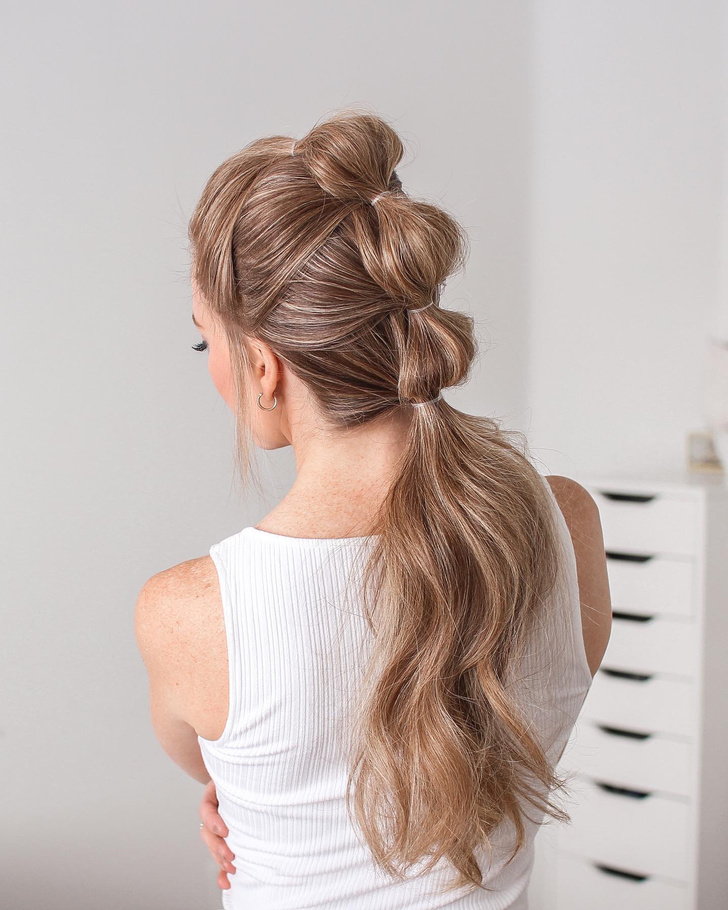 Back view of a bubble braid ponytail with a wrapped base