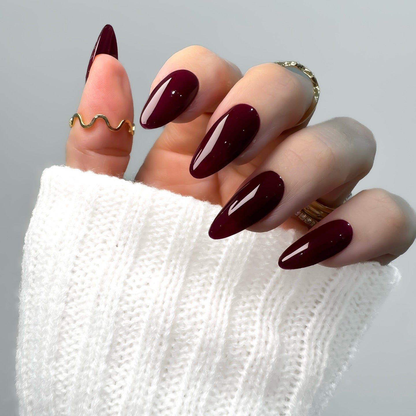 Long almond nails in plum-toned black cherry polish