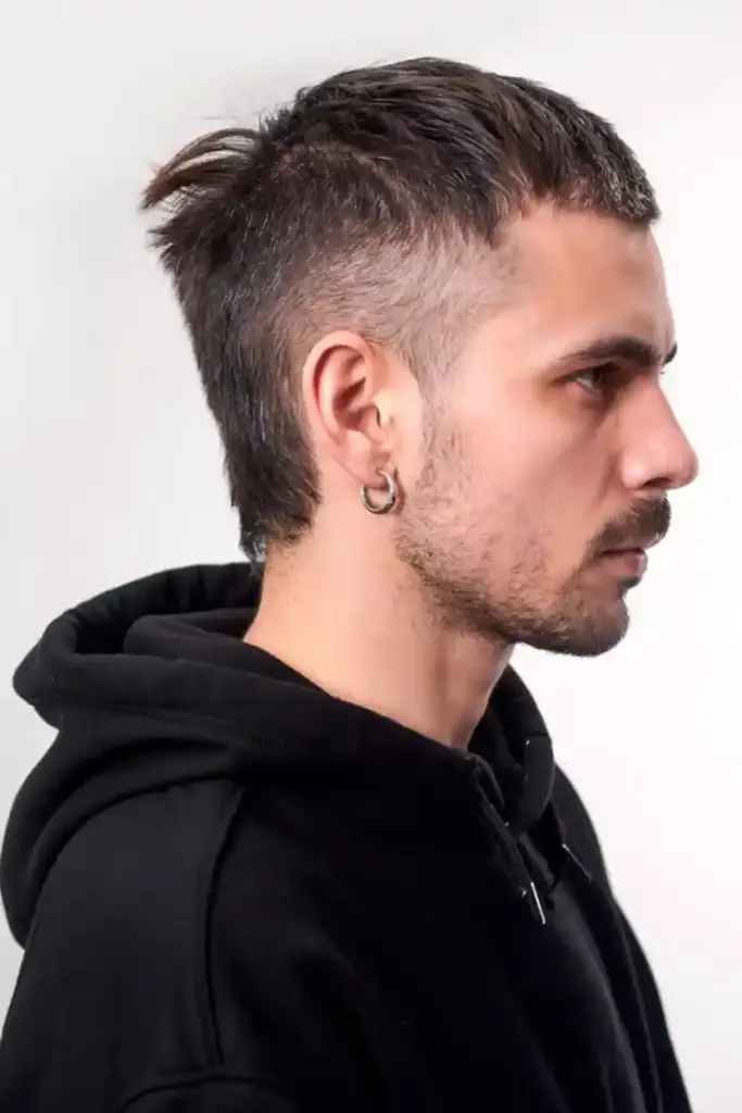 Man with a short mullet haircut and faded sides