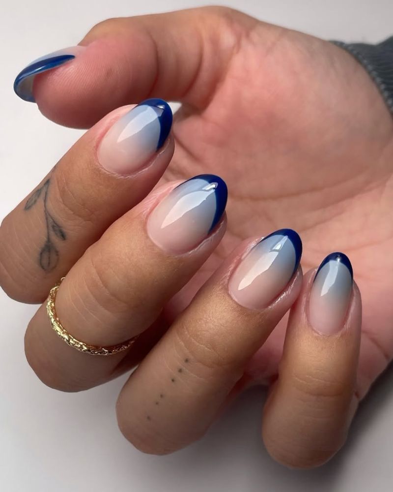 Navy blue French tip nails with dark blue tips on nude base