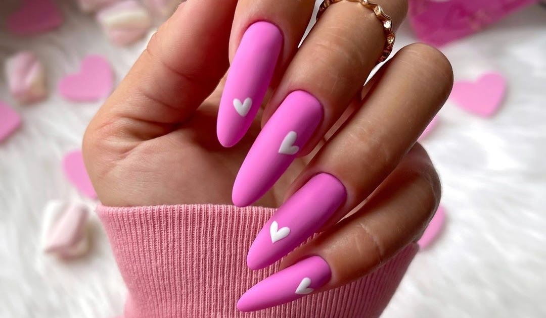 Hot pink nails with white heart nail art