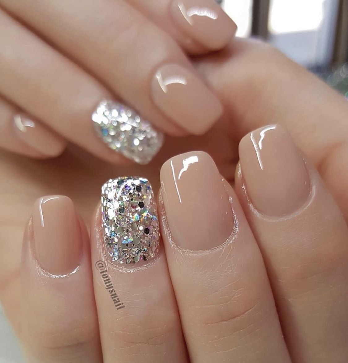 Glitter Over Nude: glitter topper over a nude base on almond nails