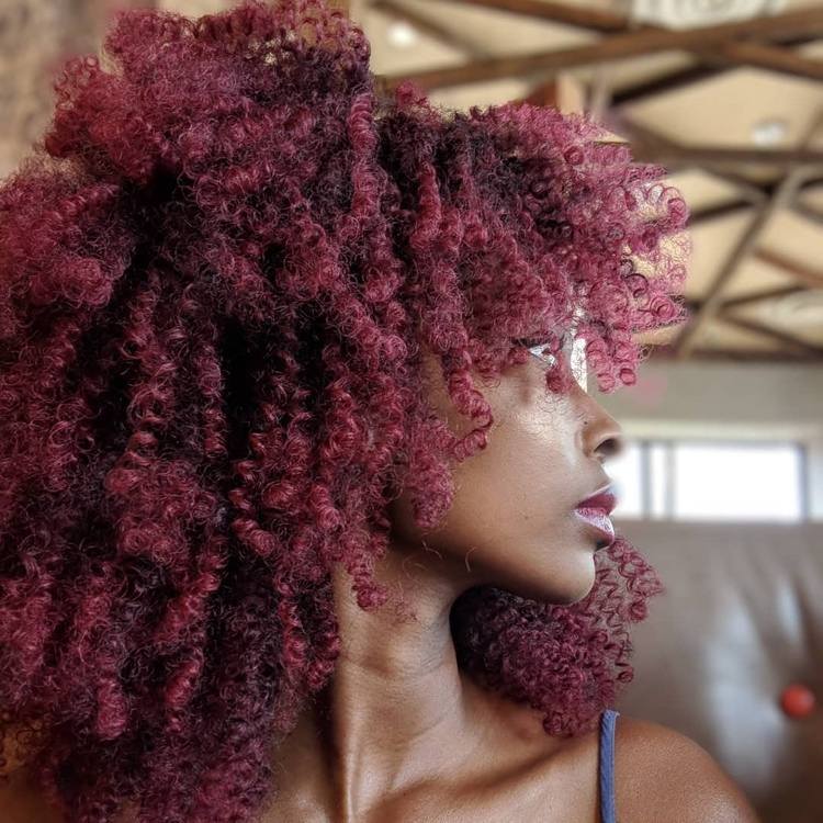 Burgundy-colored natural curly afro