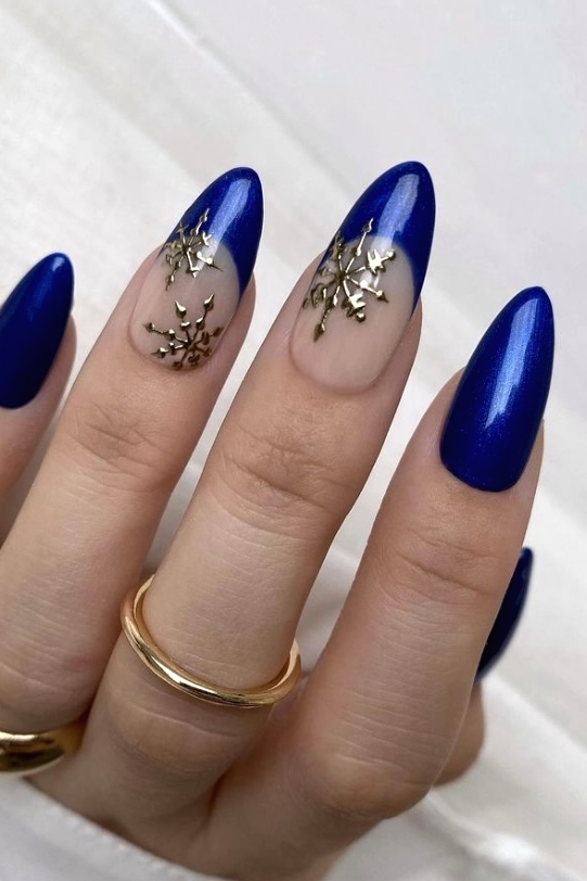 Cobalt blue almond nails with gold snowflake nail art