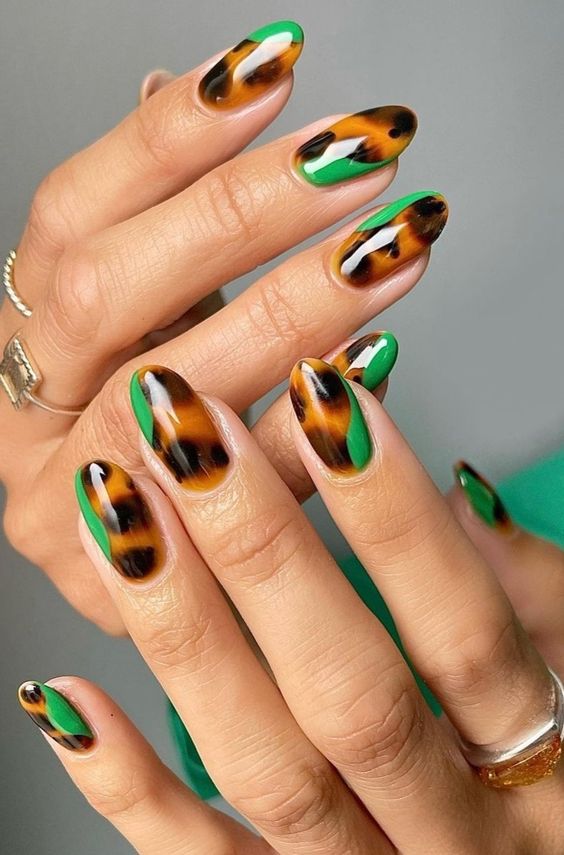 Emerald green nails with tortoise-shell accent nails