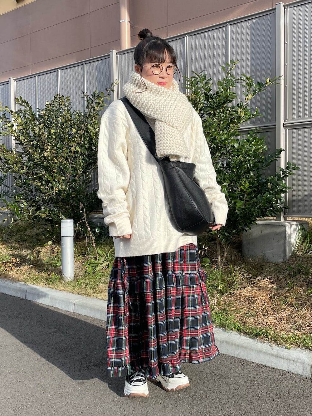 Cream cable-knit sweater and chunky scarf with red tartan plaid maxi skirt and sneakers