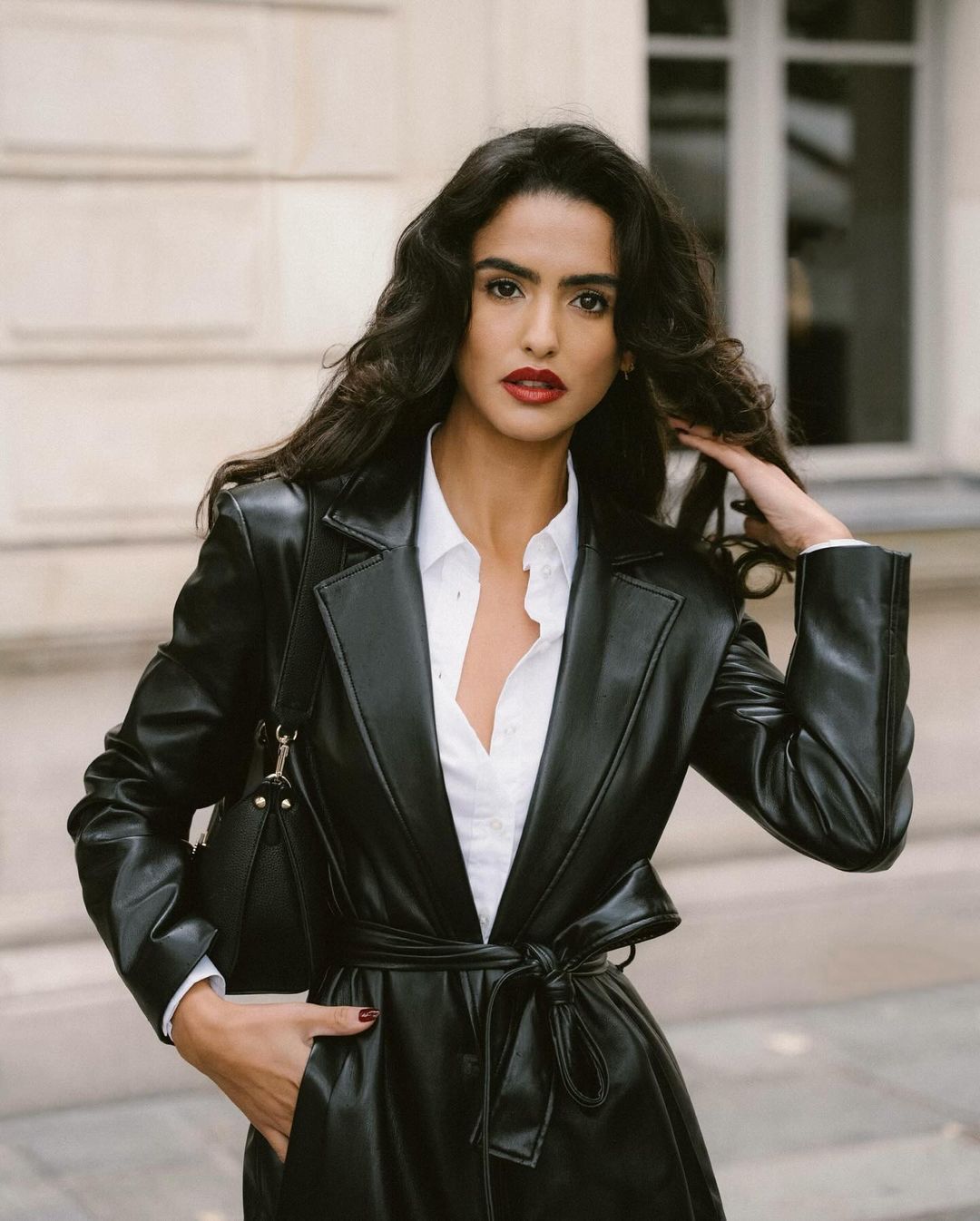 Woman wearing a leather jacket styled in a feminine way