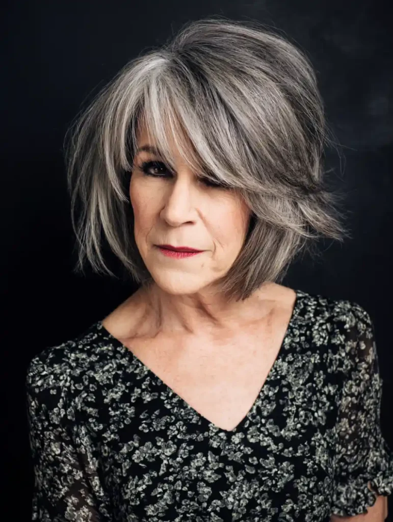Silver grey layered bob with side swept fringe on an older woman