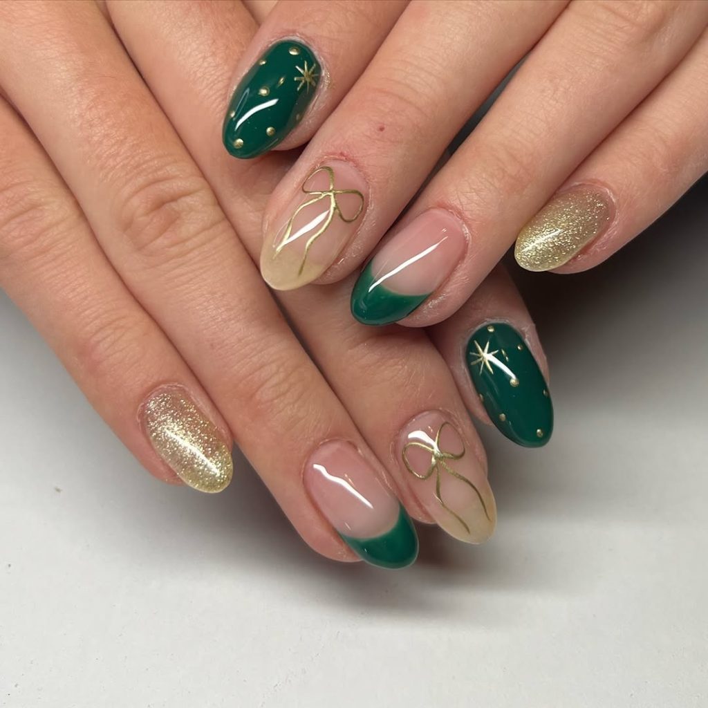 Short almond emerald green nails with gold hand-painted bow accents and gold glitter nails