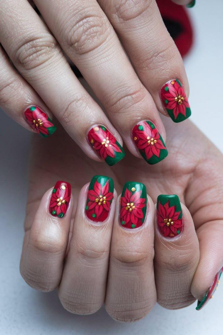 Red poinsettia nail art with gold bead centers on red and green nails