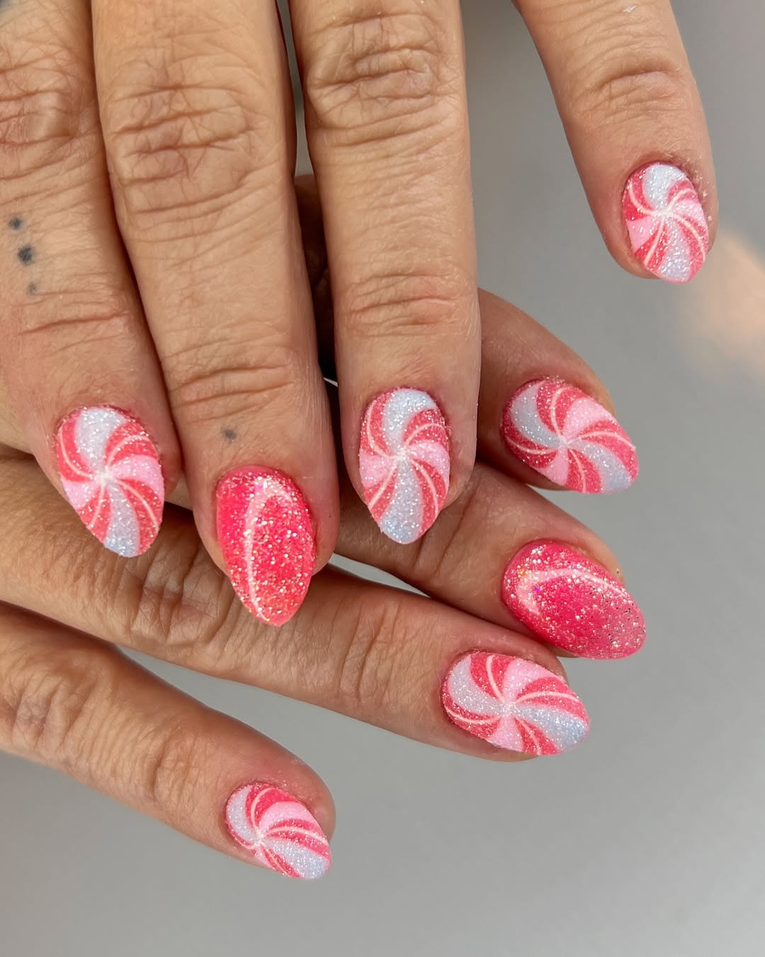 Pink and white peppermint swirl nails