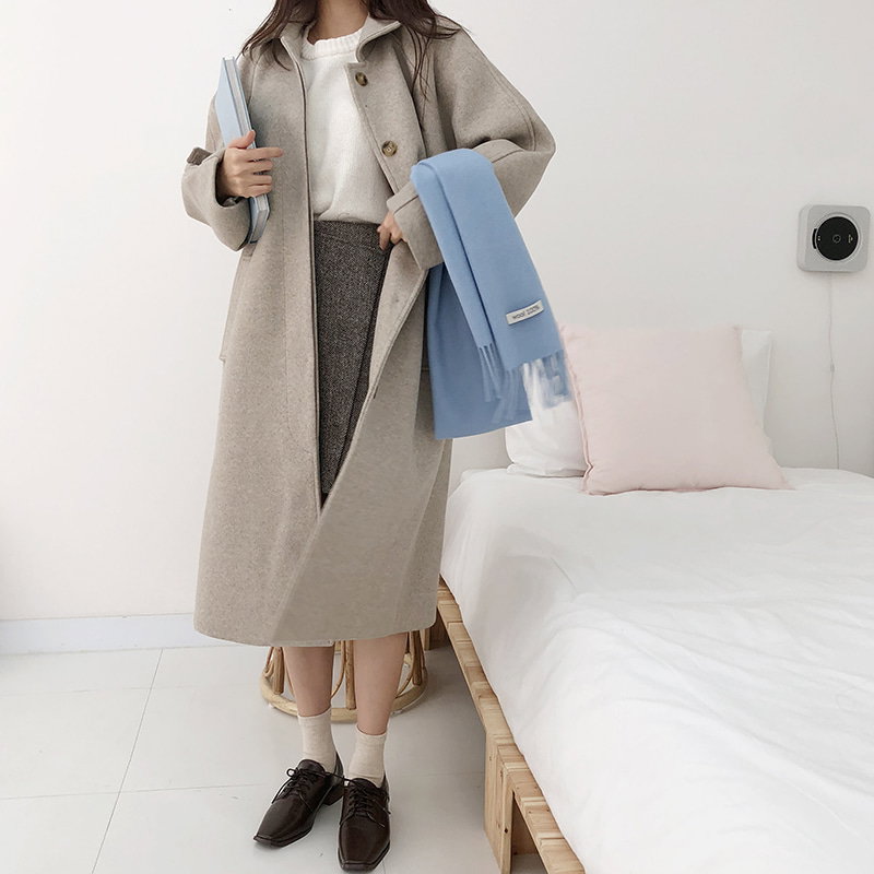 Woman in an oversized wool coat with a large scarf