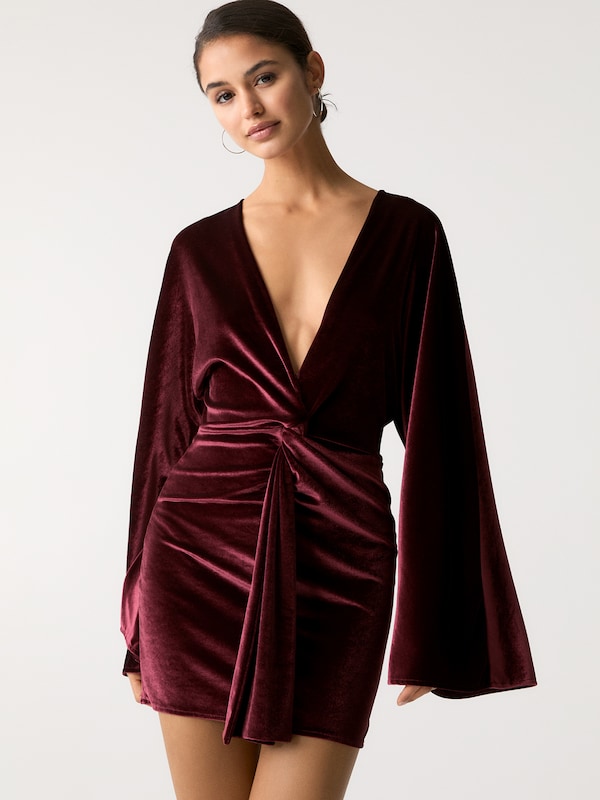 Burgundy velvet wrap dress styled for a winter party