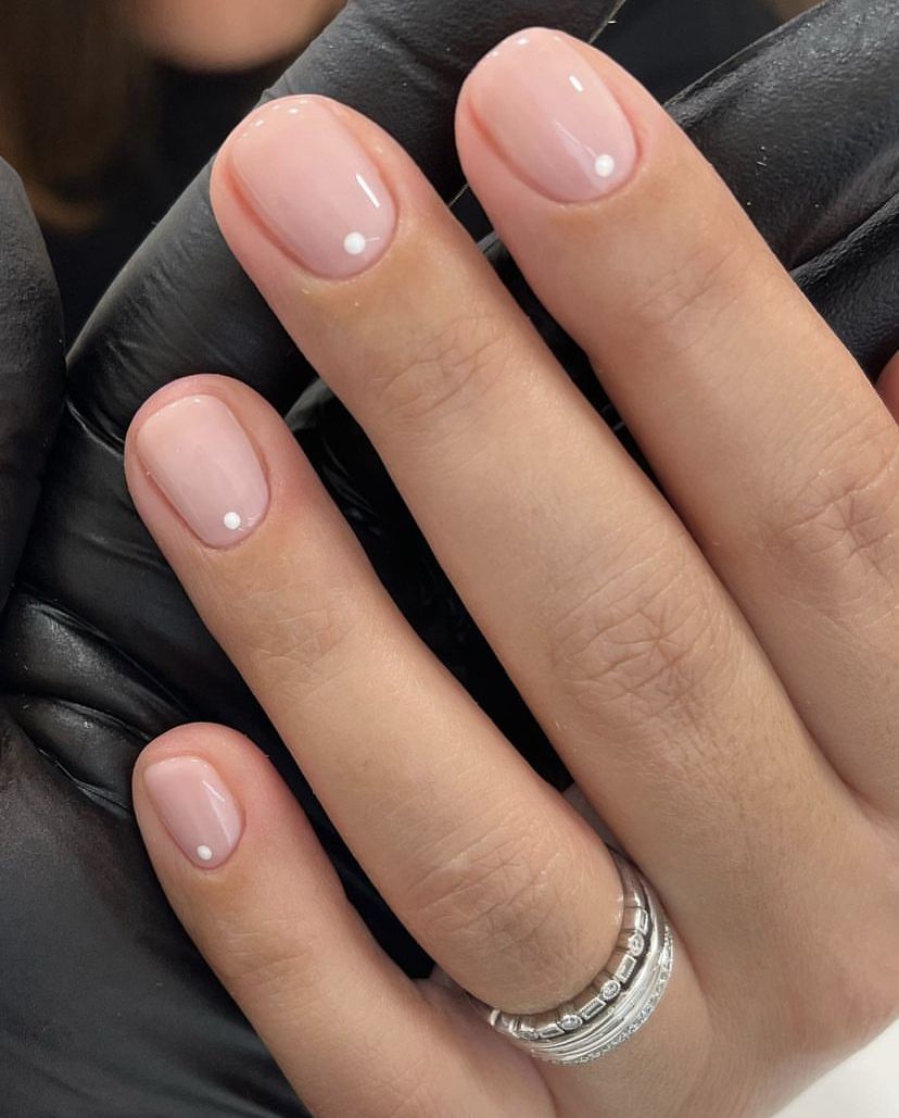 Nude nails with tiny white dot accents