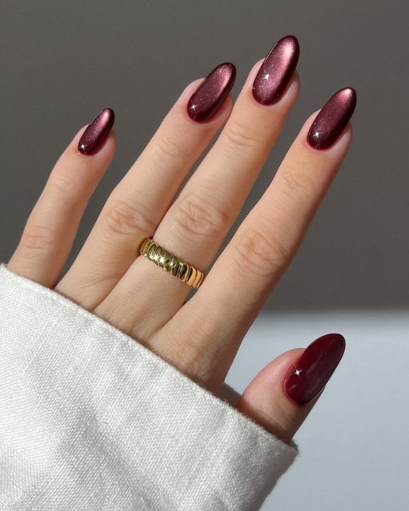 Burgundy cat-eye velvet almond nails with shifting magnetic sheen
