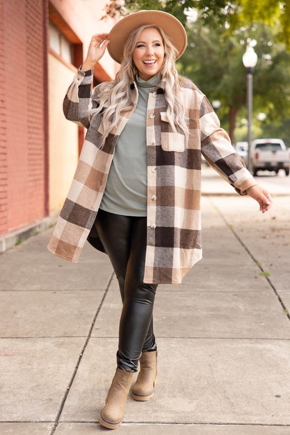 Woman wearing a plaid shacket with leggings and boots