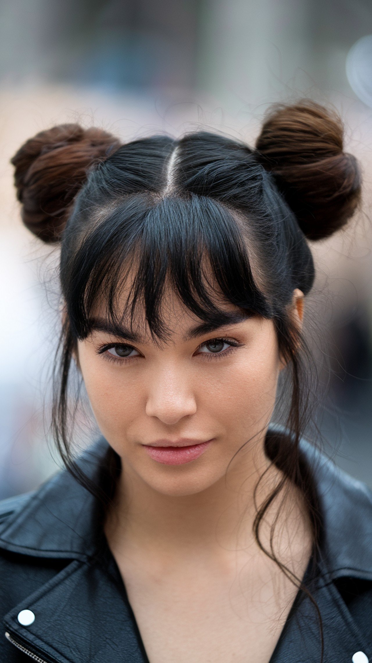 Woman with double space buns and wispy bangs
