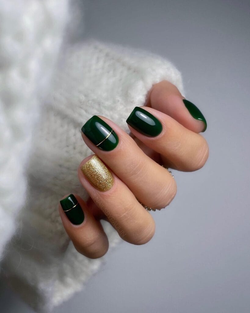 Forest green winter nail art with gold accents