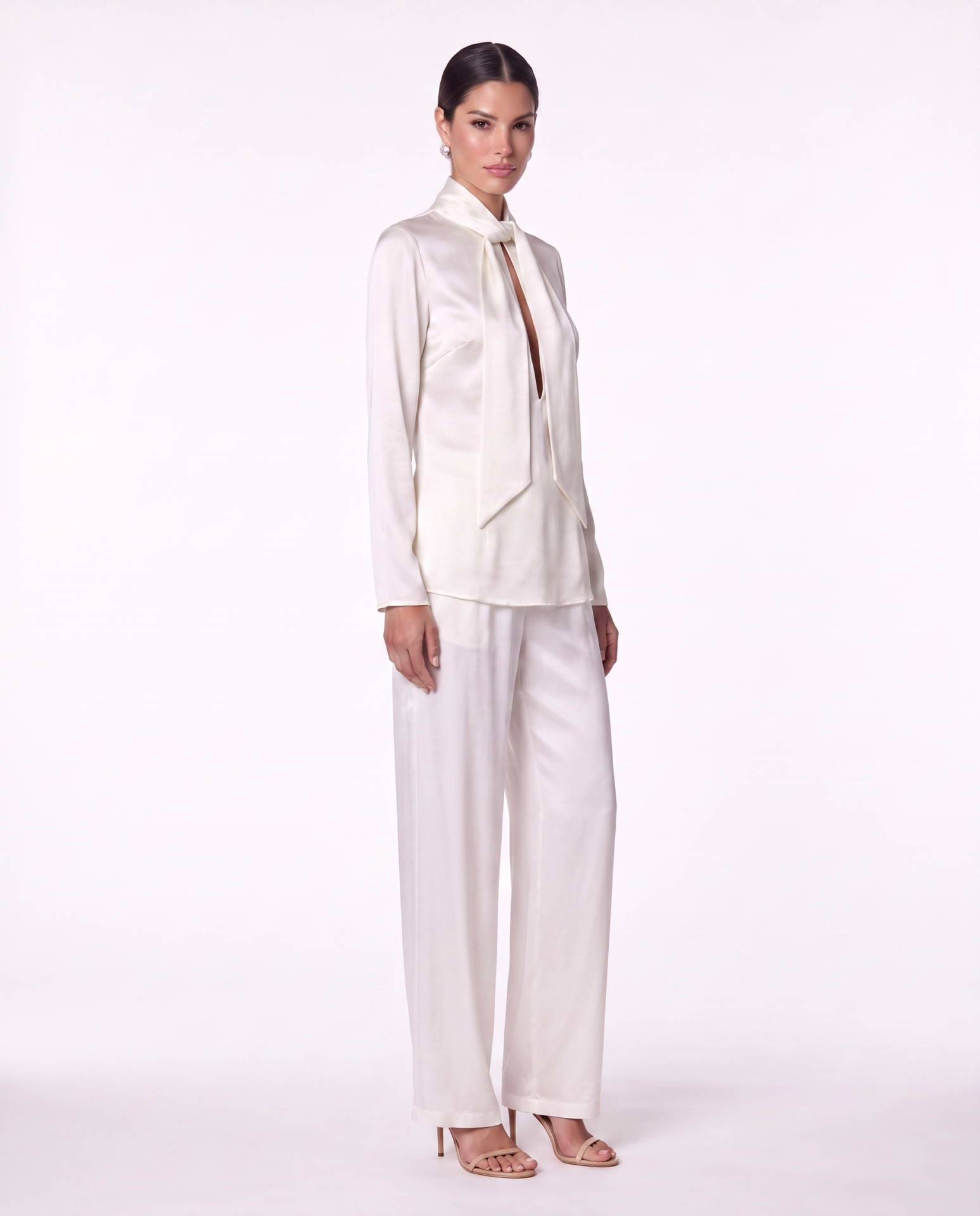 Ivory satin scarf-tie blouse with matching silk wide-leg trousers and nude heels