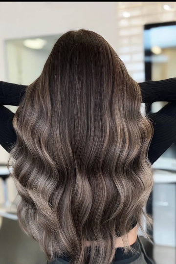Long wavy hair with ash brown ombre from dark mushroom roots to ash blonde ends