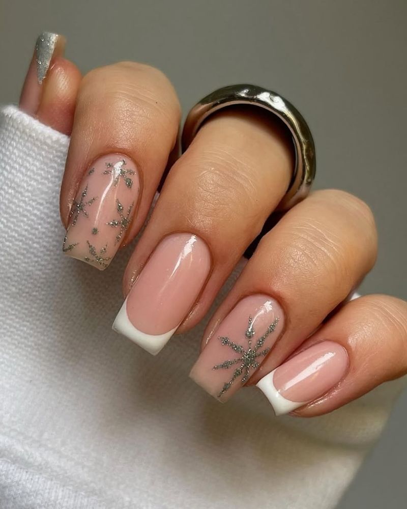 Square French tip nails with snowflake accent