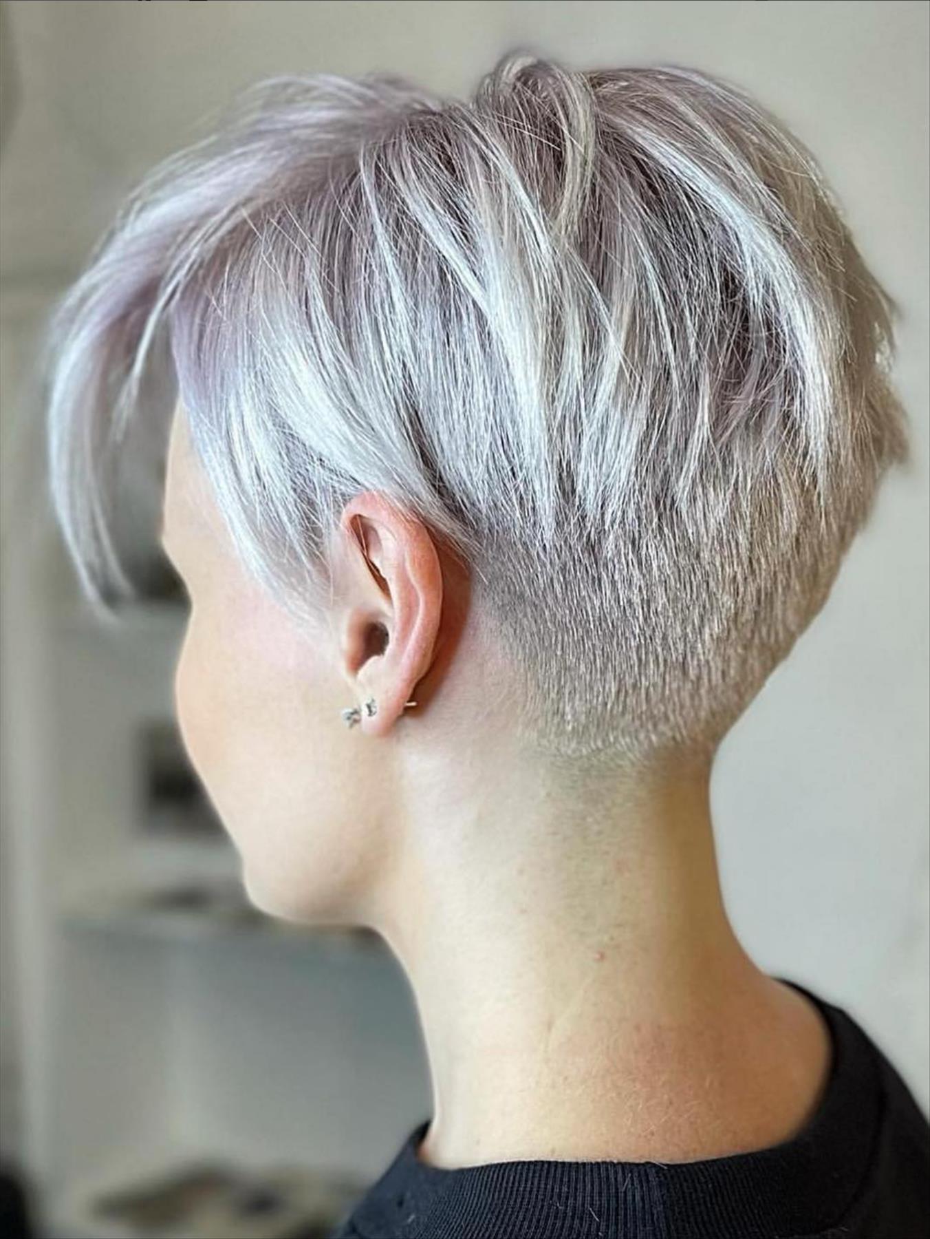 Icy silver pixie cut with tapered back and long side-swept fringe