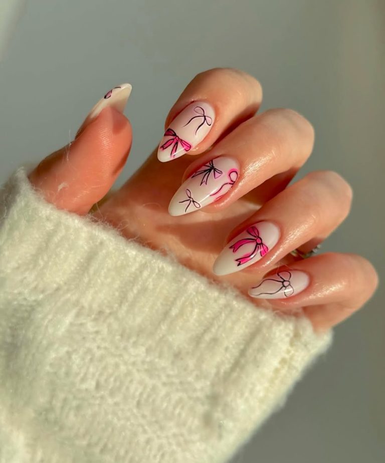 Milky white almond nails with hand-drawn pink and black bow outlines