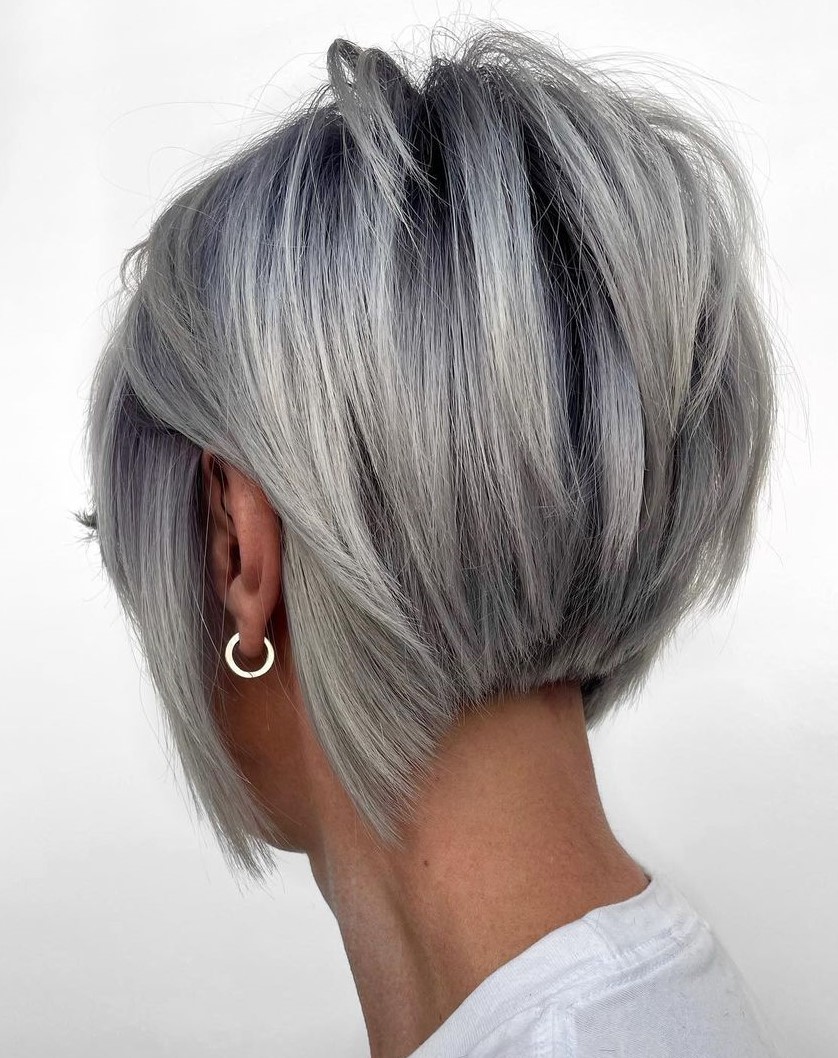 Back-side view of a stacked silver-grey graduated bob with dark shadow roots