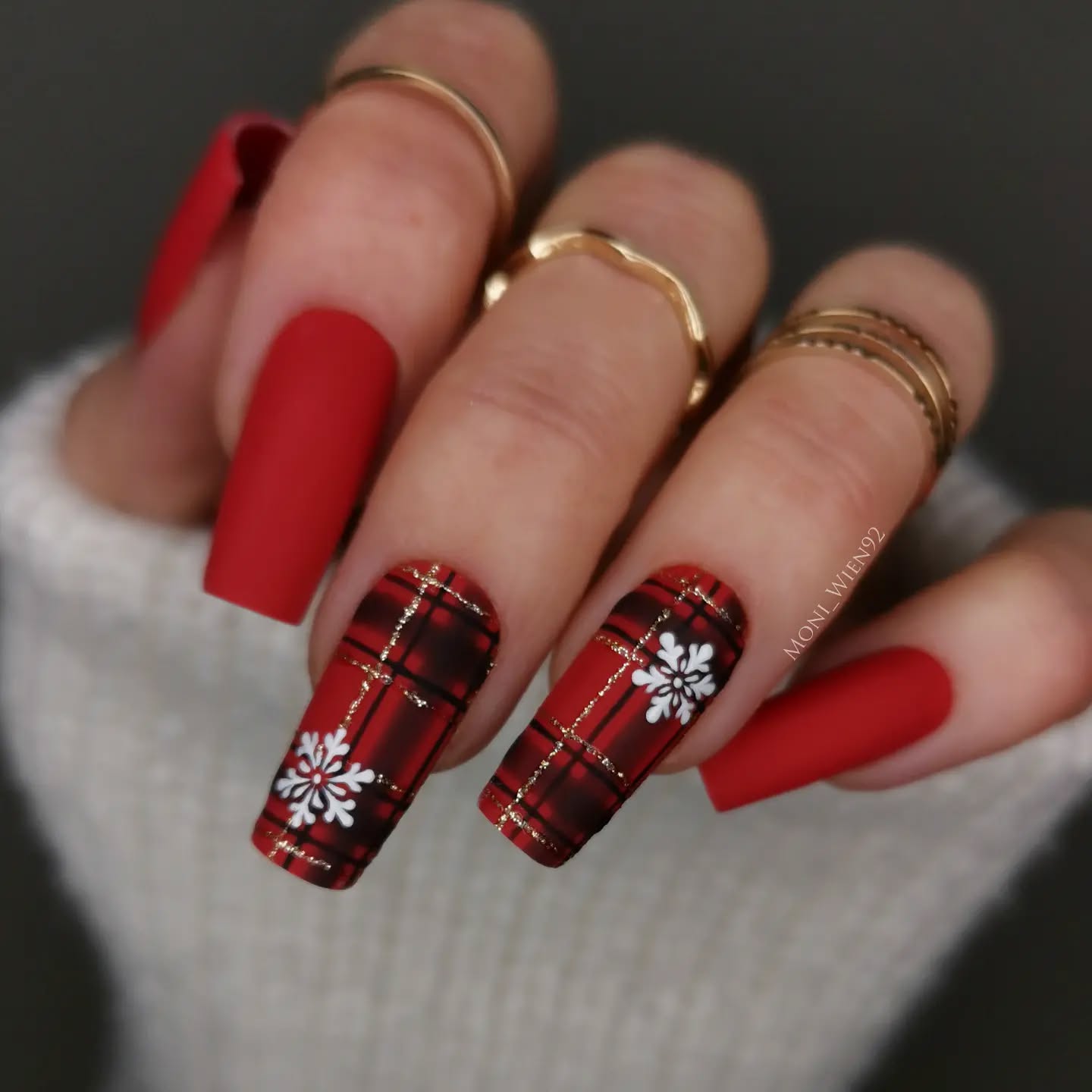 Long matte red coffin nails with tartan plaid accent nails, gold stripes and snowflake art