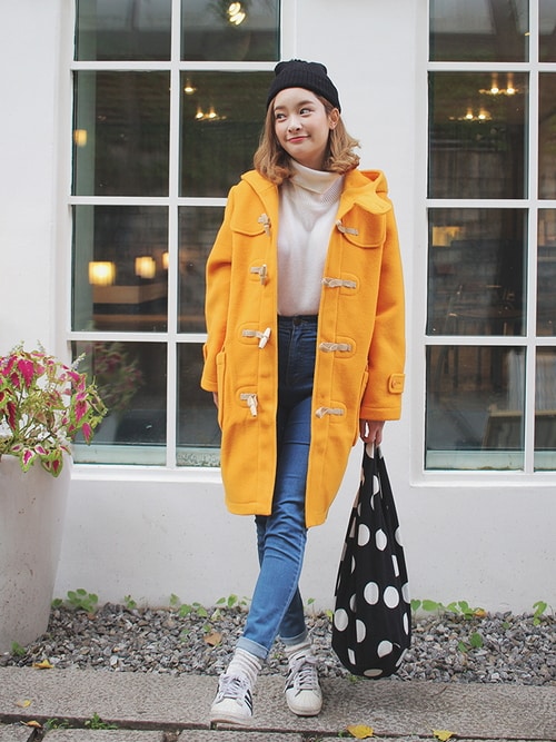 Mustard toggle duffle coat with skinny jeans, sneakers, and a polka-dot tote