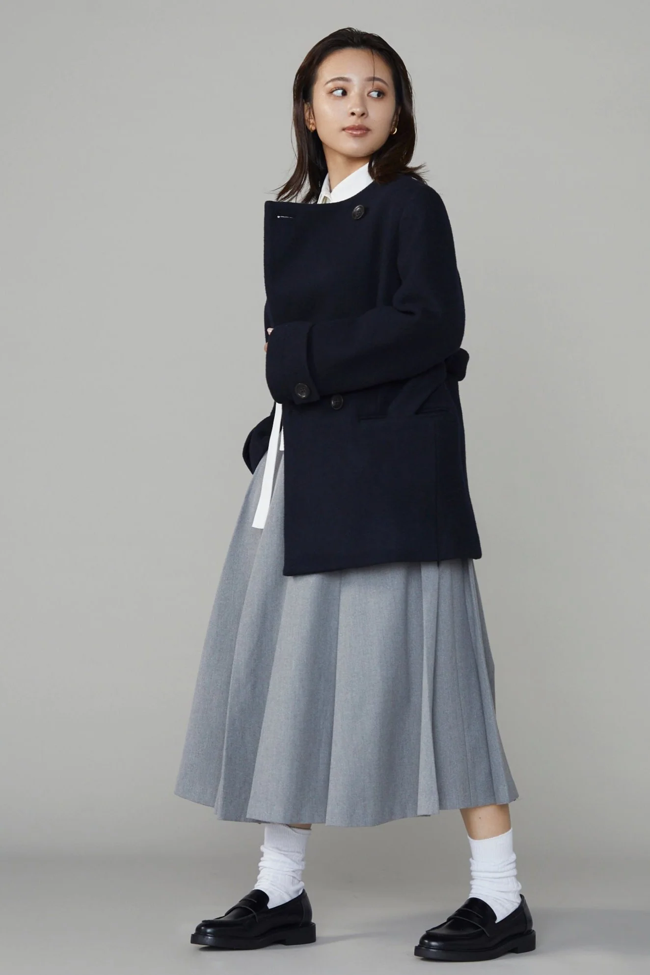 Woman wearing a navy double-breasted car coat
