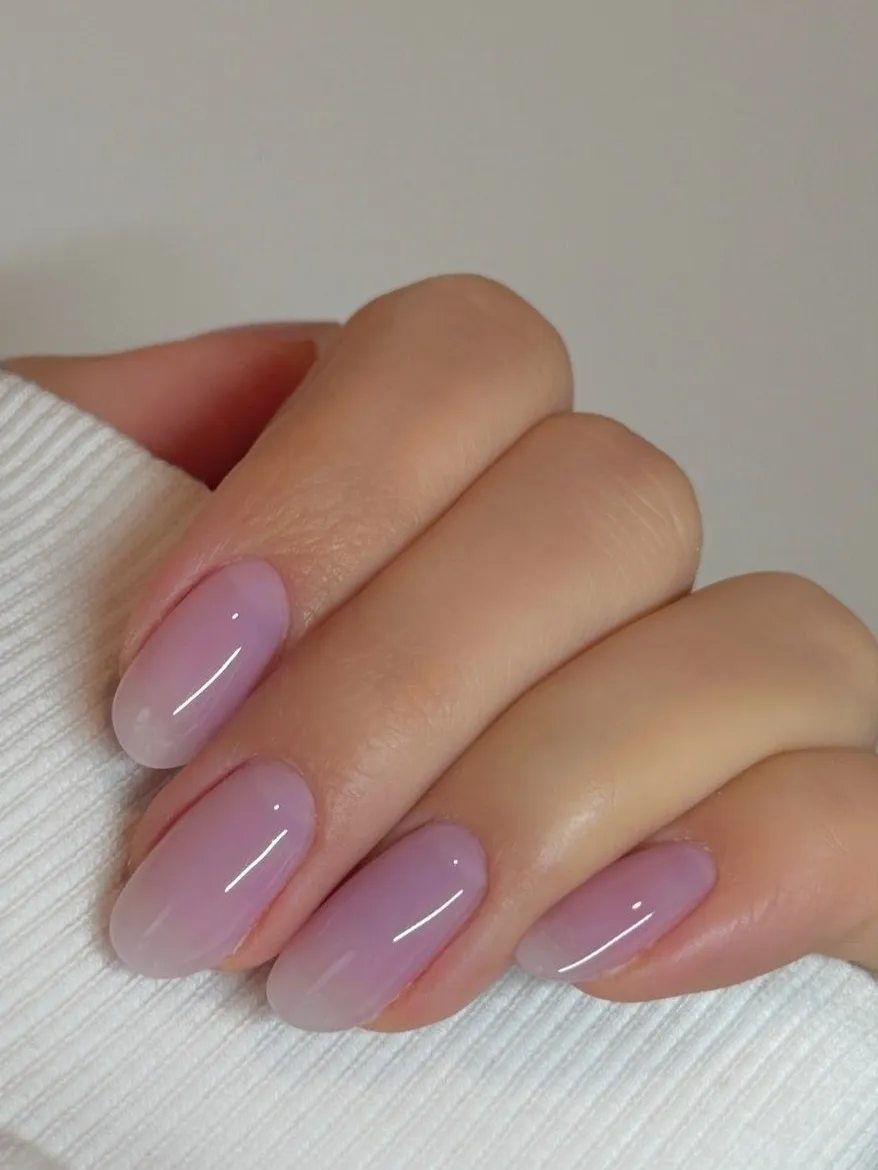 Short almond nails with frosted lilac ombre fading to white tips