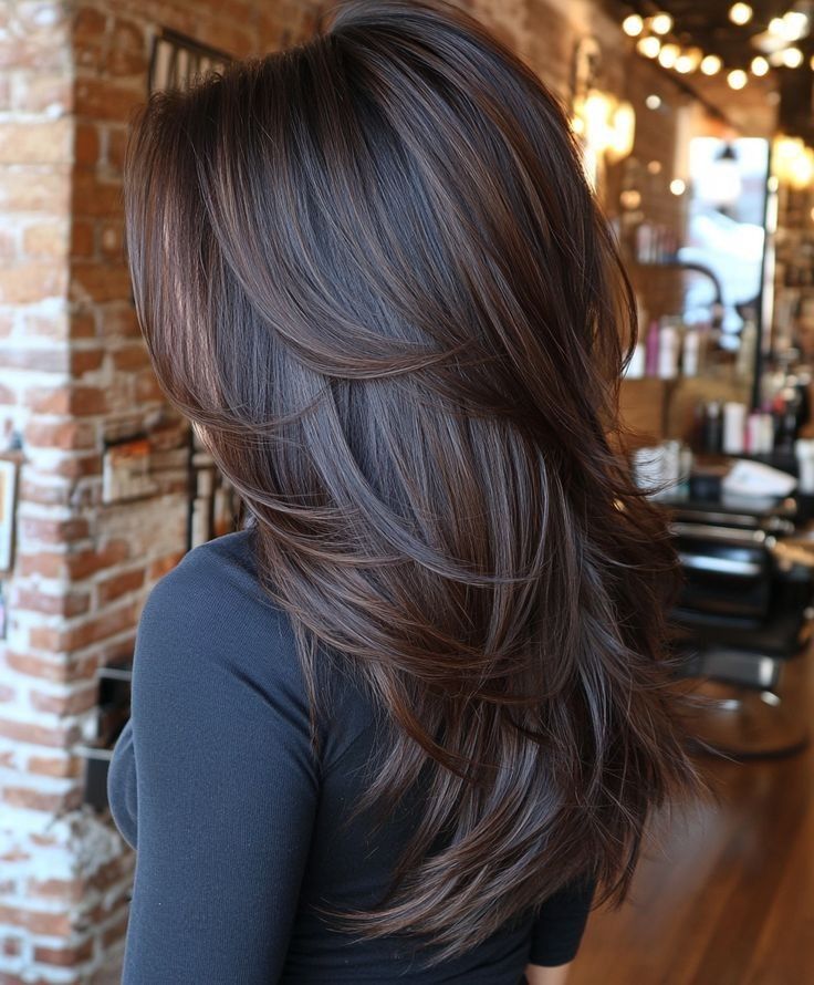 Dark brown long layered hair with chocolate and toffee ribbon highlights