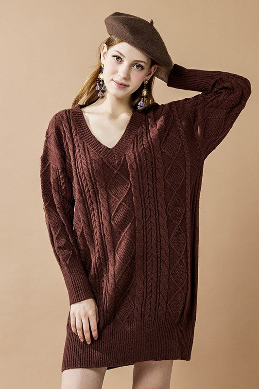 Woman wearing a beret with a cable-knit sweater dress