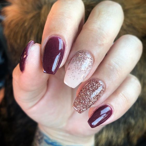 Coffin nails in glossy wine red with rose gold glitter ombre and full glitter accent nails