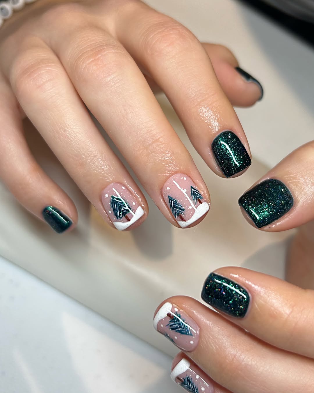 Short dark green glitter Christmas nails with pine tree nail art