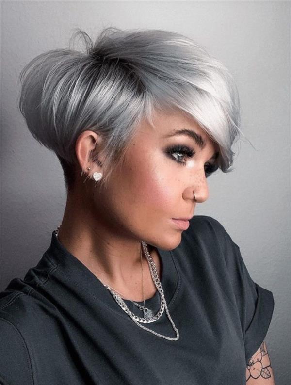 Asymmetrical silver pixie haircut with long side swept bangs