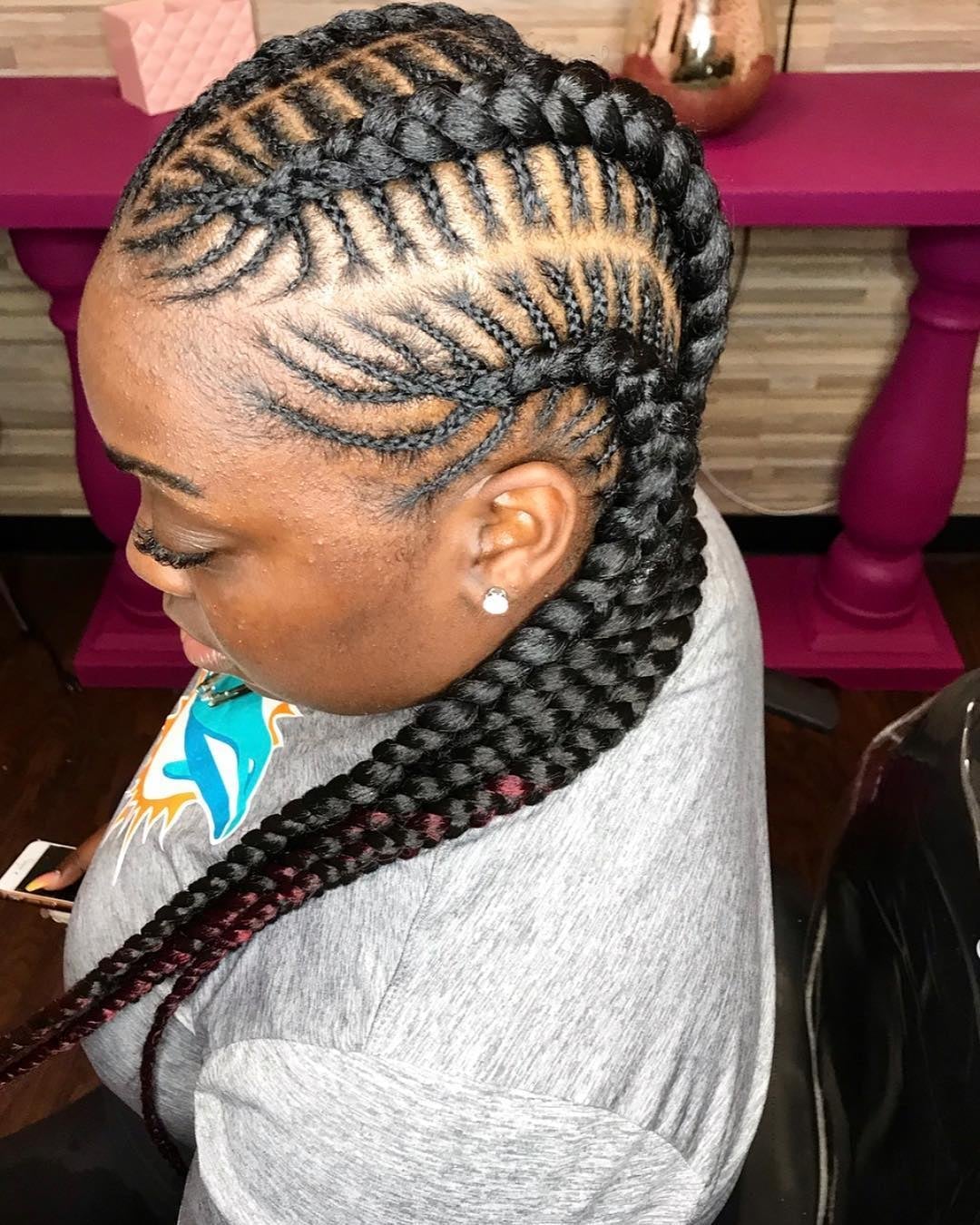 Black feed-in braids melting into auburn red tips pulled into a ponytail