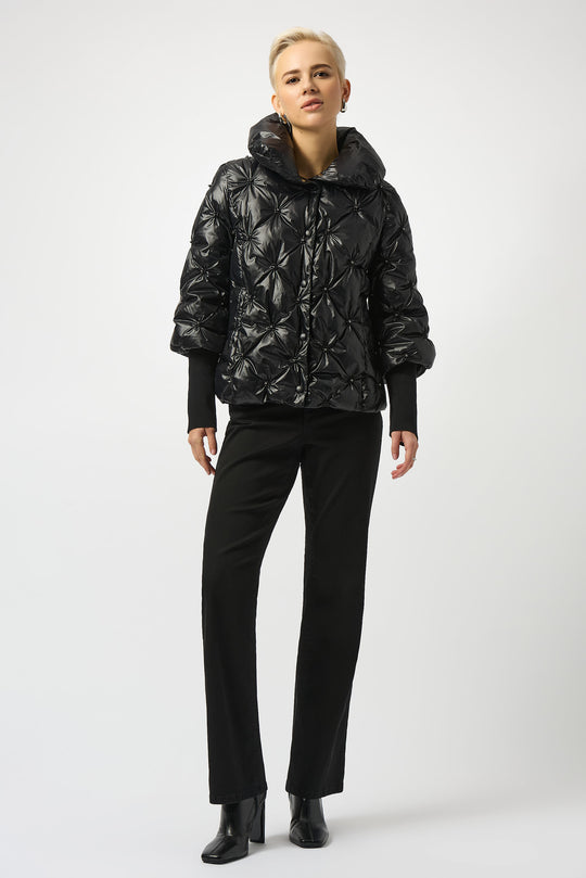Woman in a quilted puffer jacket over an all-black outfit