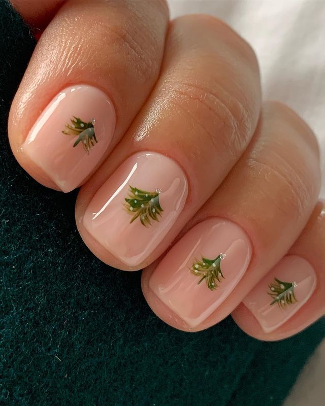 Sheer pink nails with green Christmas tree nail art