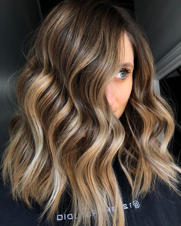 Dark blonde base melting into golden caramel balayage ends