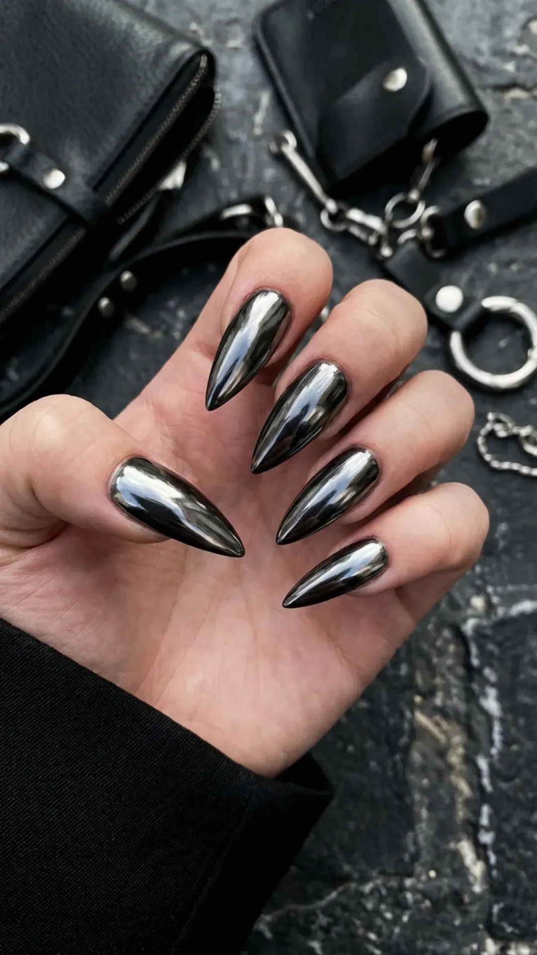 Gunmetal chrome stiletto nails with a dark metallic shine