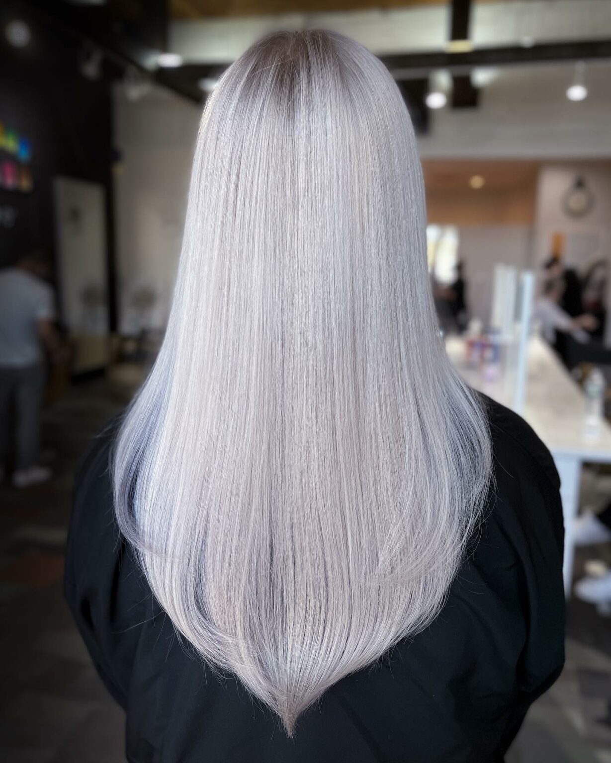 Long straight icy platinum hair with silver lowlights, back view