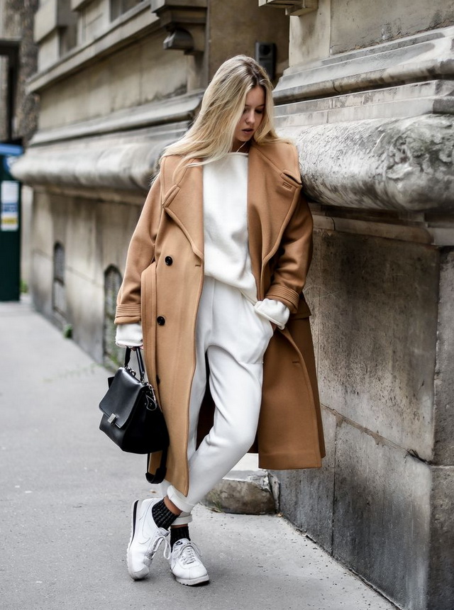 Woman in a long camel coat in a street-style look