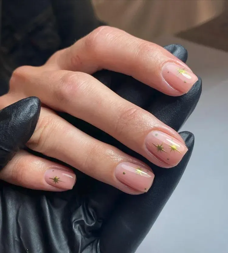 Sheer nude short square nails with tiny gold star dots
