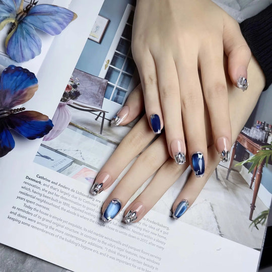 Coffin nails alternating deep navy blue and silver mirror chrome with small rhinestone accents