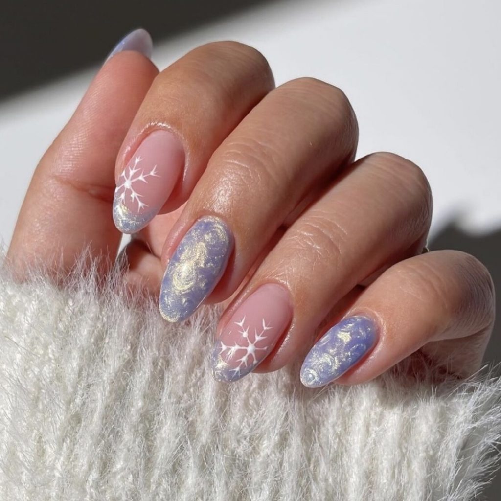 Short oval lavender nails with white snowflake nail art and silvery shimmer accents