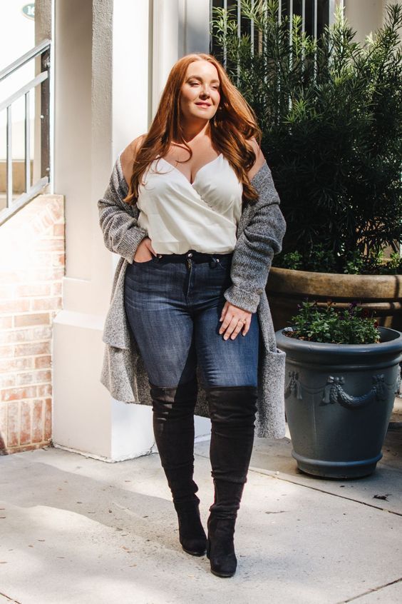 Skinny jeans with a white wrap top and black over-the-knee boots
